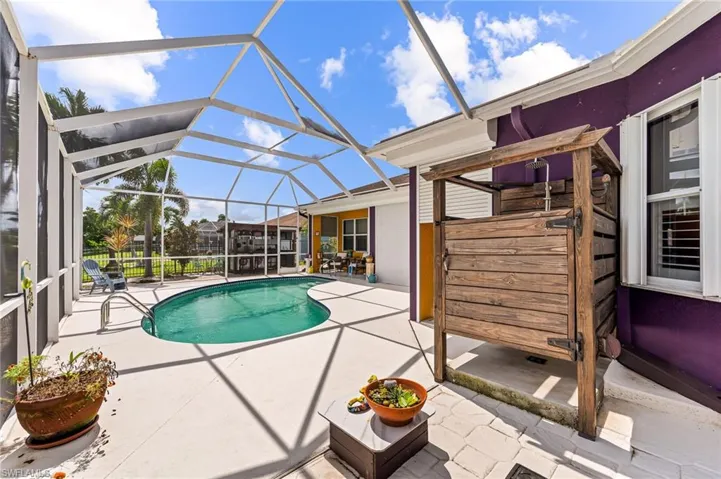 View of swimming pool with a lanai and a patio area
