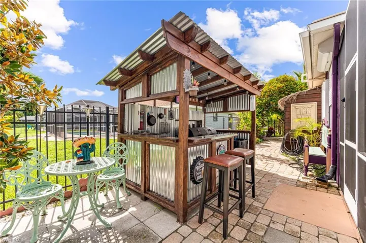View of patio with a pergola and an outdoor bar
