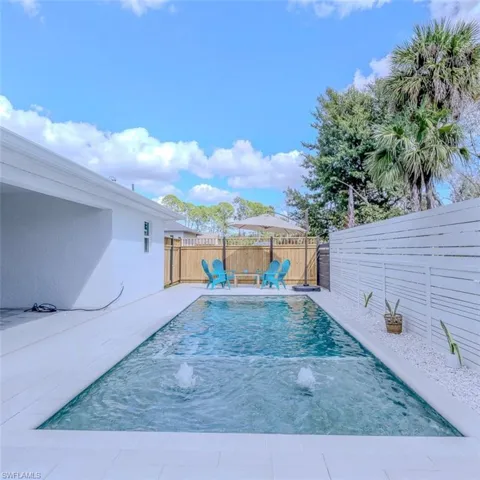 View of pool featuring a fenced backyard and patio surround