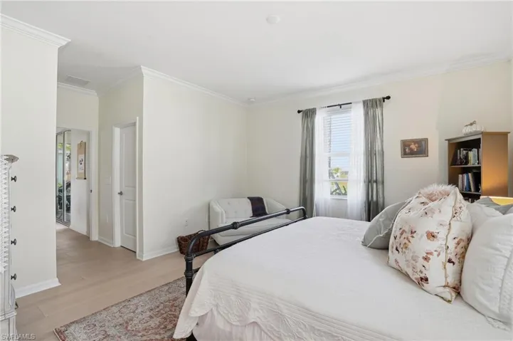 Bedroom featuring ornamental molding and light wood-type flooring