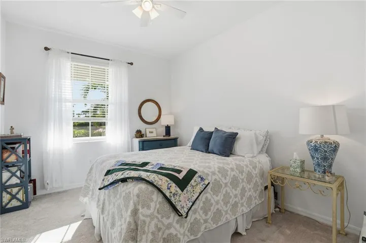 Bedroom with light carpet and ceiling fan