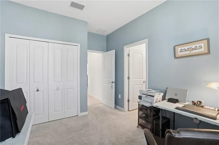 Office area with light carpet and baseboards