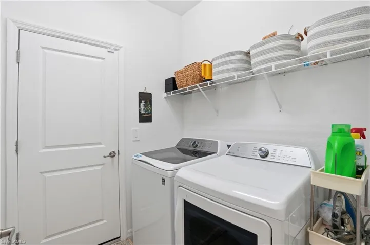 Laundry room with washing machine and clothes dryer