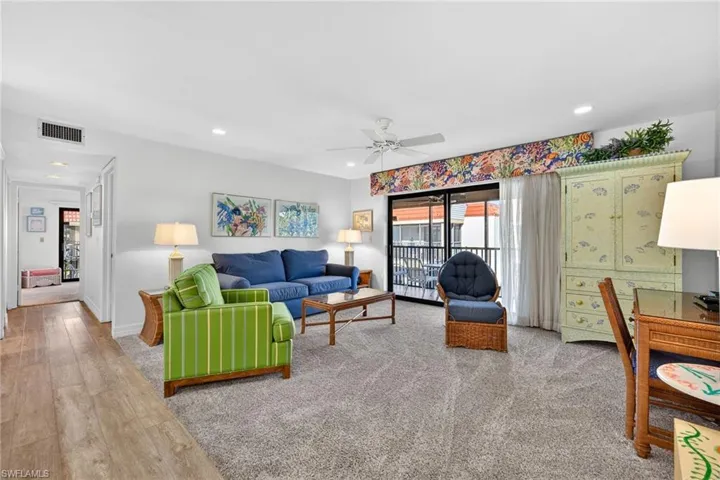 Living area featuring light wood-style flooring, recessed lighting, and a ceiling fan