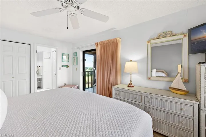 Bedroom with a textured ceiling, ceiling fan, access to outside, and a closet