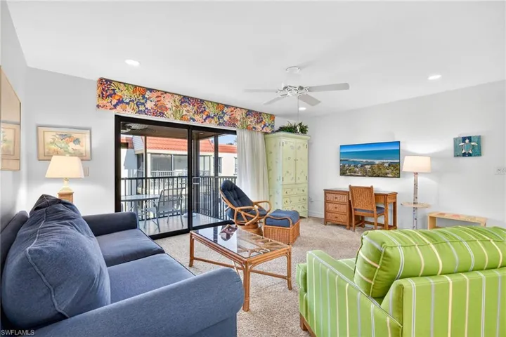 Living area with carpet flooring, a ceiling fan, and recessed lighting