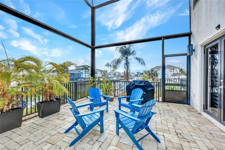 View of patio featuring a sunroom, a residential view, and area for grilling