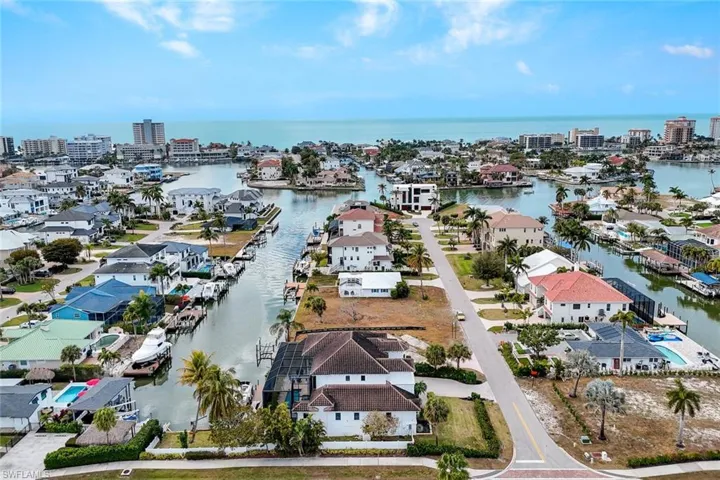 Aerial perspective of suburban area featuring a large body of water