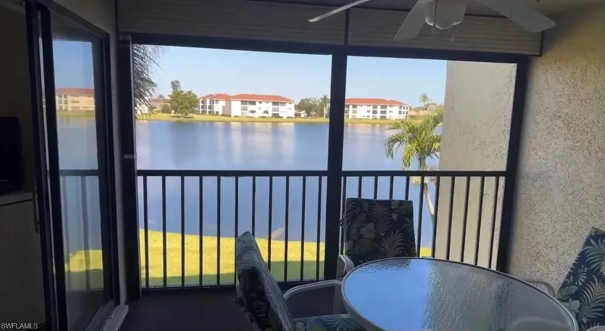 Balcony with a water view and ceiling fan