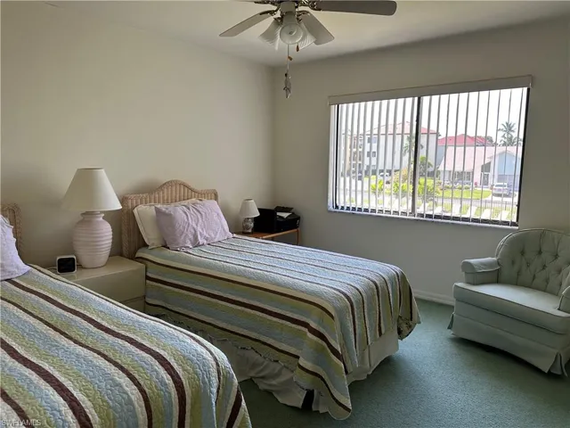 Bedroom with carpet and ceiling fan