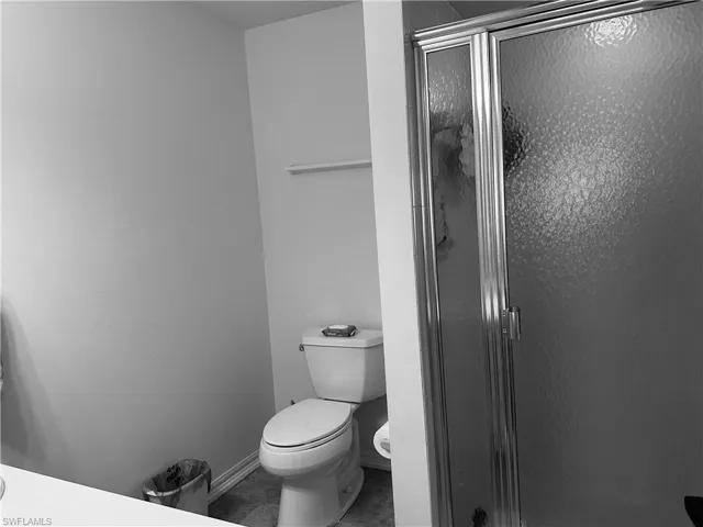 Bathroom featuring toilet and an enclosed shower