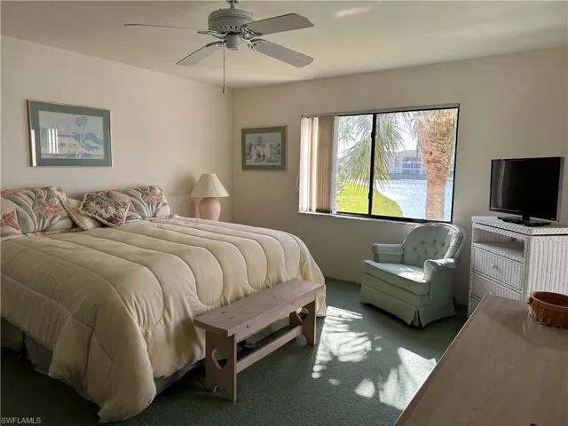 Carpeted bedroom with ceiling fan