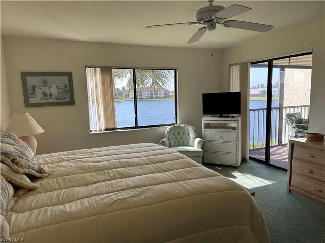 Bedroom with multiple windows, carpet flooring, access to outside, and ceiling fan