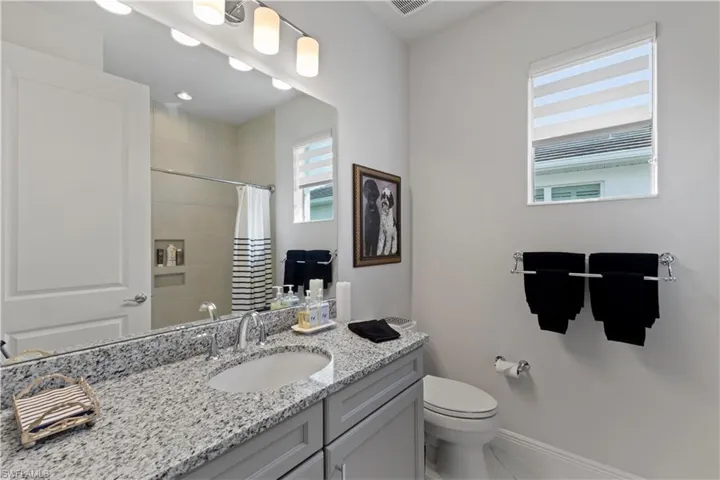Bathroom with vanity, tile patterned flooring, and toilet