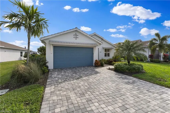 Single story home featuring a garage and a front yard