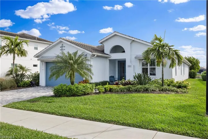 View of front of house featuring a garage and a front lawn