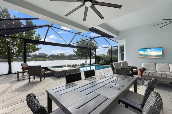 Extended covered lanai featuring a water view and ceiling fan