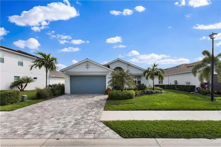 Single story home with a garage, central AC, and a front yard
