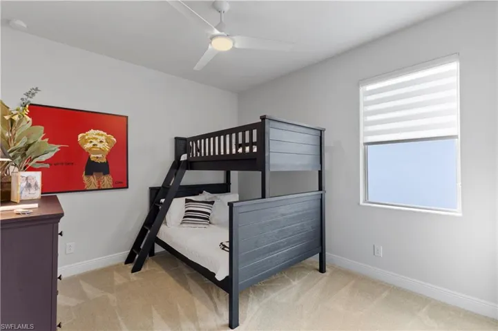 Bedroom featuring light carpet and ceiling fan