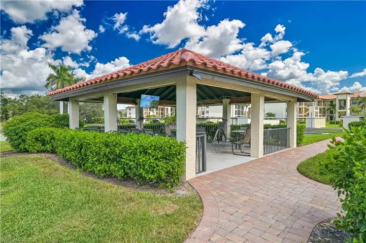 View of home's community featuring a patio area and a lawn
