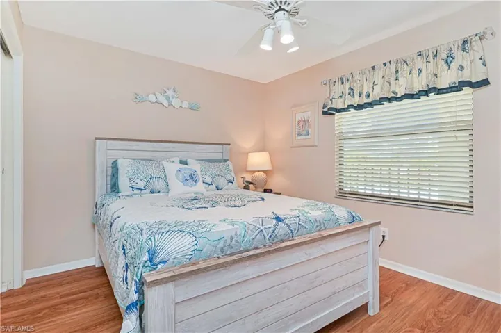 Bedroom with light wood-style flooring and a ceiling fan