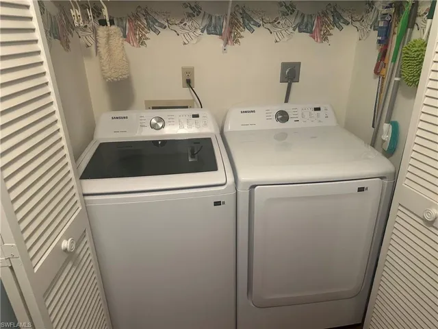 Washroom with new washer and clothes dryer