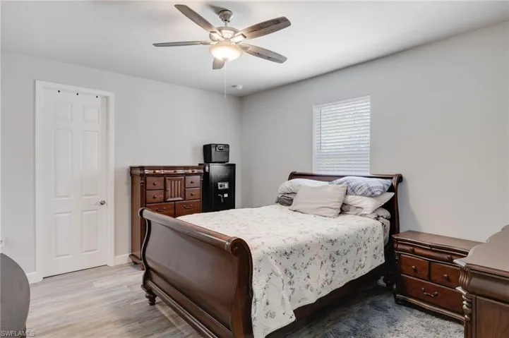 Bedroom with ceiling fan and hardwood / wood-style flooring