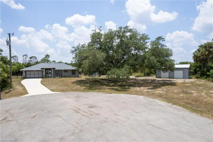 View of front facade with a garage and a front lawn