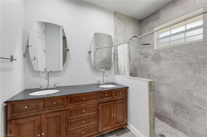 Bathroom with walk in shower and double sink vanity
