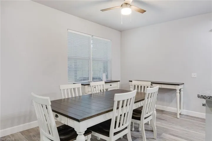 Dining space with hardwood / wood-style flooring and ceiling fan