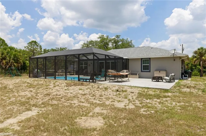 Back of property with a lanai and a patio area