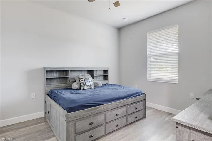 Bedroom featuring ceiling fan and light hardwood / wood-style flooring