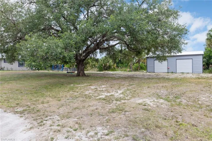 View of yard with a garage and an outdoor structure