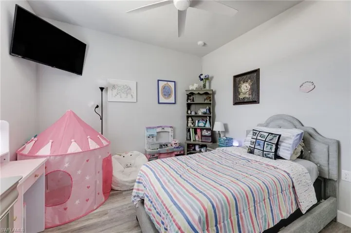 Bedroom with light hardwood / wood-style floors and ceiling fan