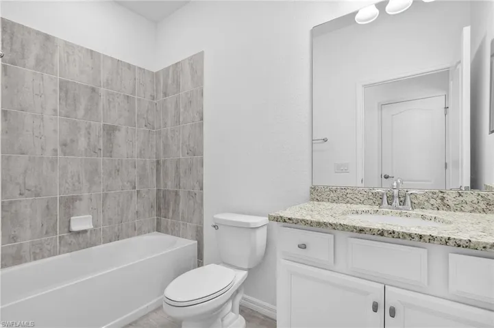 Guest Bathroom with vanity, toilet, and bathtub / shower combination