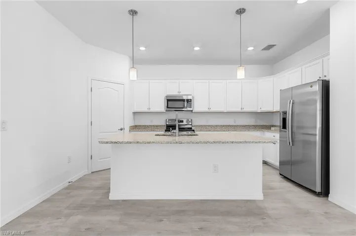Kitchen with recessed lighting and pendant lights