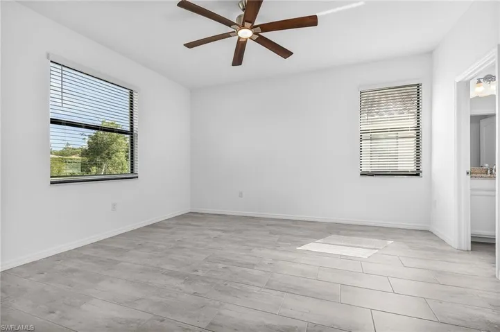 Primary suite with 2 large walk in closets and ceiling fan