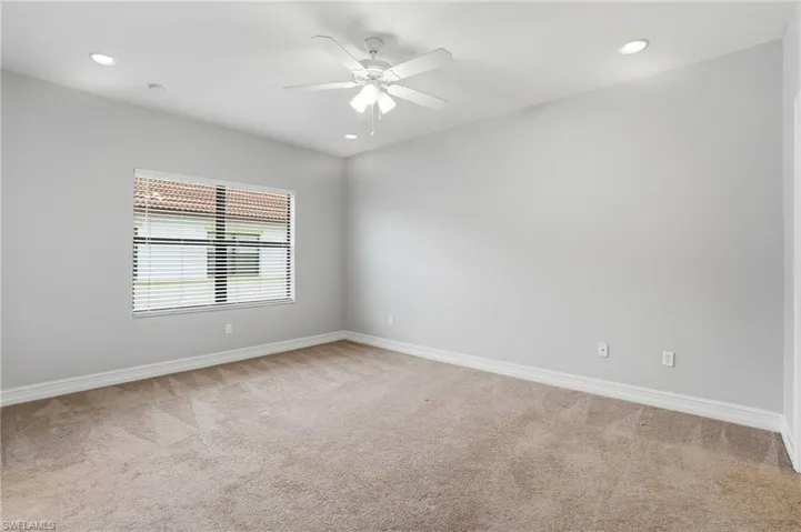 Empty room with light colored carpet, recessed lighting, and a ceiling fan