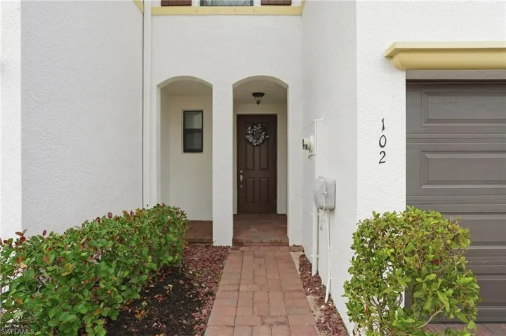 View of exterior entry with stucco siding