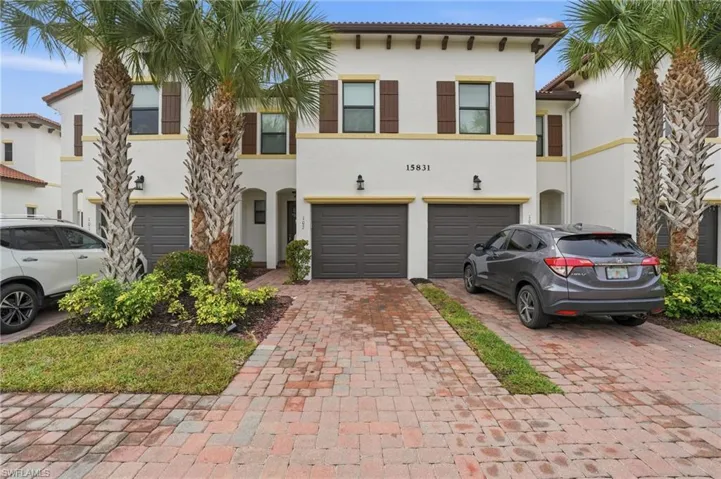 Mediterranean / spanish-style house featuring stucco siding, decorative driveway, a tile roof, and a garage