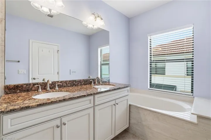 Bathroom with double vanity and a garden tub