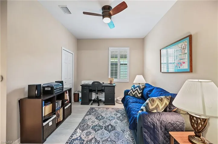 Living area featuring ceiling fan and light wood-type flooring