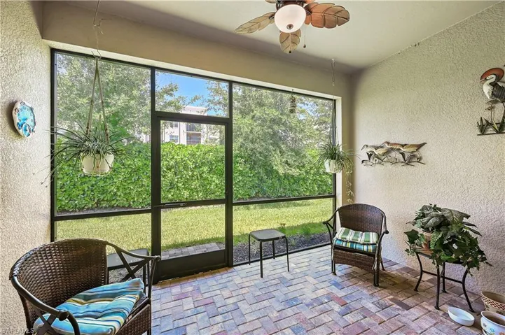 Sunroom / solarium featuring ceiling fan