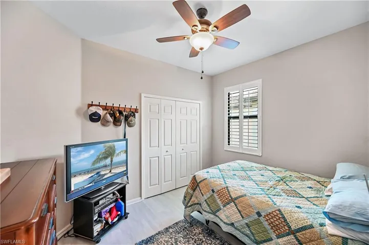 Bedroom featuring a closet, ceiling fan, and light hardwood / wood-style floors