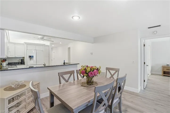 Dining area featuring light LVPnfloors, a ceiling fan, and recessed lighting
