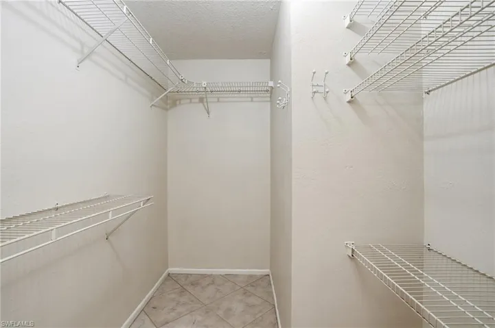 Walk in closet featuring light tile patterned flooring