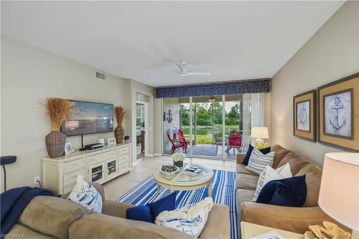 Spacious living area featuring neutral wall tones and tile flooring