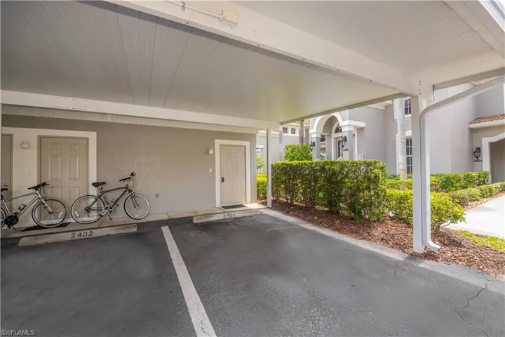 Covered carport parking space with a smooth asphalt surface