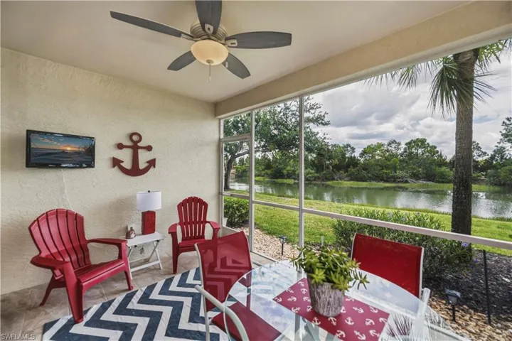 Screened lanai featuring textured walls, tiled flooring, and a ceiling fan