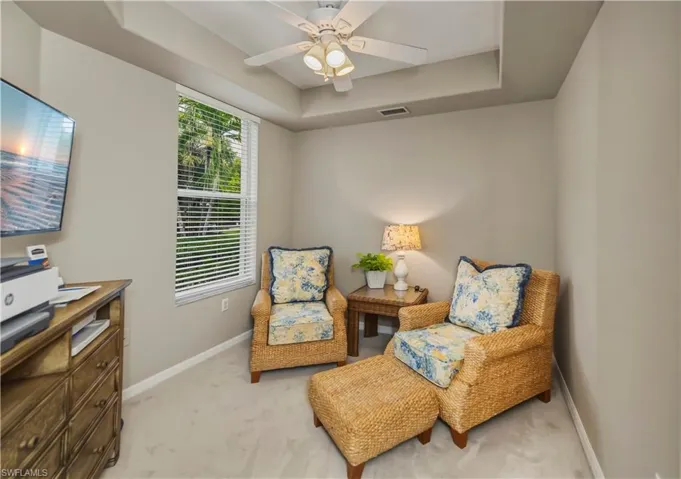 Room with tray ceiling and ceiling fan